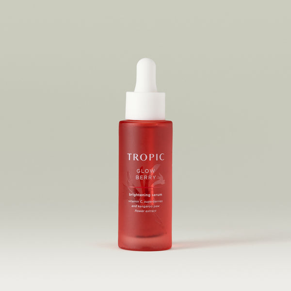 Tropic Glow Berry brightening serum. Vitamin C, superberries and kangaroo paw flower extract. Deep red glass bottle with embossed floral design behind white text.