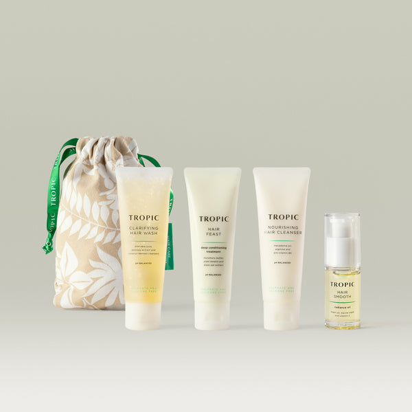 Haircare discovery kit includes minis of; clarifying hair wash, hair feast, nourishing hair cleanser and hair smooth and a grey leaf patterned bag with forest green drawstring
