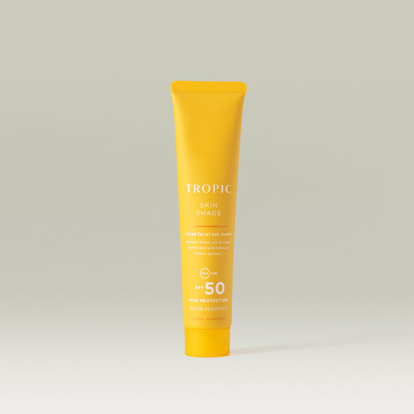 Tropic Skin shade tinted facial sun cream SPF 50. Yellow tube with white text. High protection and water resistant.