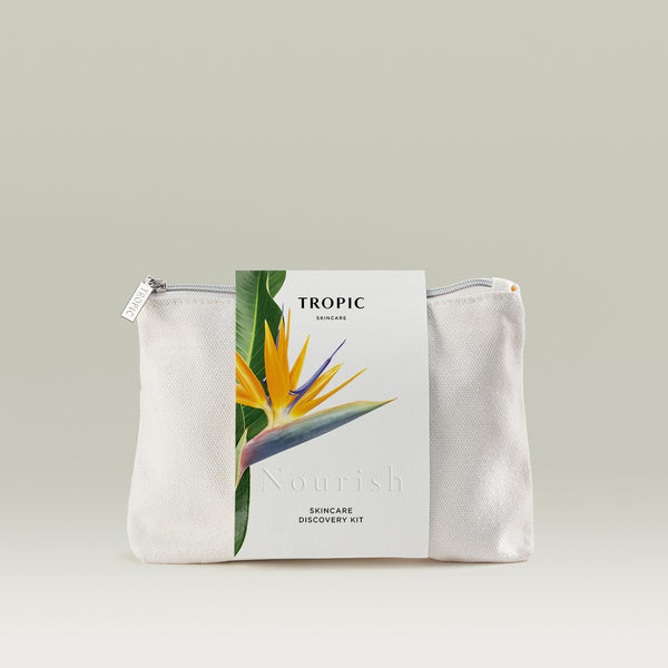 Tropic Skincare Discovery Kit – Nourish edition, shown in a white zip travel bag with a label featuring a vibrant Bird of Paradise flower.