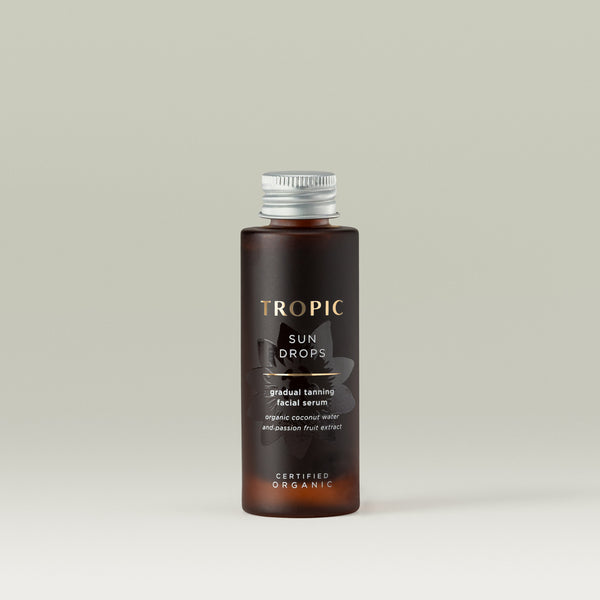 Tropic Sun Drops gradual tanning facial serum 30ml refill has a silver screw top, brown bottle with embossed flower behind the text which reads: organic coconut water and passion fruit extract.  It's Certified Organic.