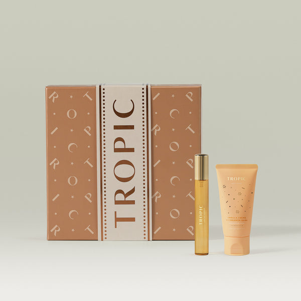 The Vanilla Crème & Cinnamon Bark Fine Fragrance and Body Cream Set from Tropic, featuring a decorative gift box with a body cream tube and fine fragrance bottle displayed in front.
