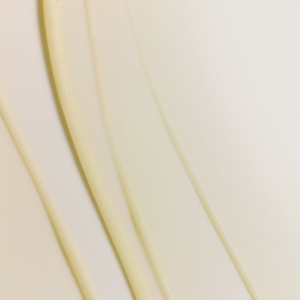 Macro texture of Tropic Lip Fudge in shade Clear, showing smooth, glossy swirls for a hydrating lip finish.