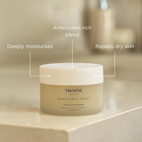 Tropic Whipped Body Velvet jar shown on a neutral stone surface, highlighting antioxidant-rich formula benefits, including deep moisturisation and care for dry skin.