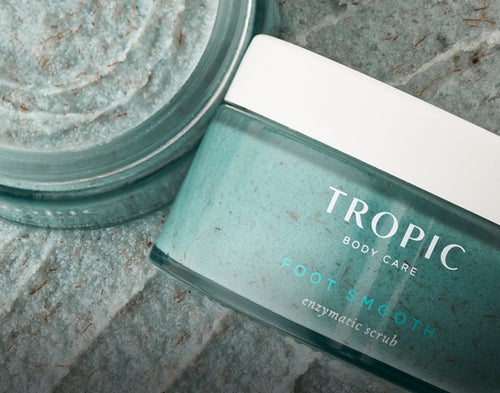 Tropic Foot Smooth with texture of product in the background.