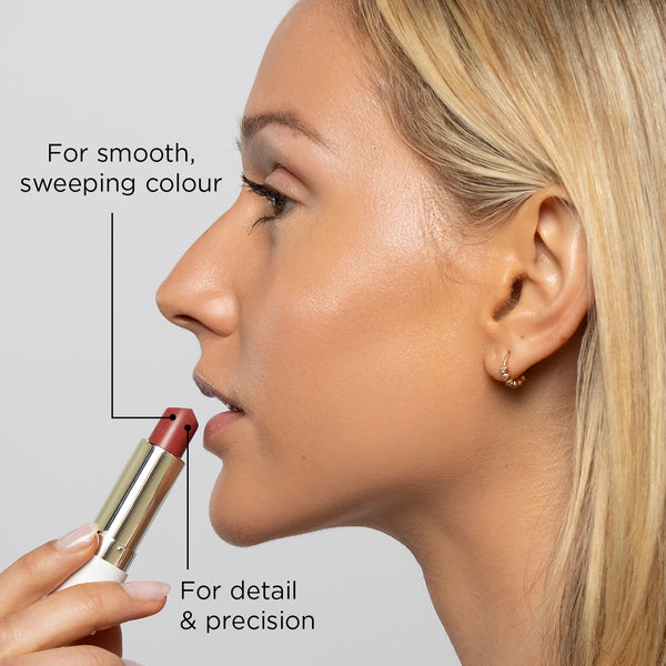 Model is facing the side and holding a butter tint lip & cheek balm in her hand as she is about to apply to her lips.

Annotations about the product read: For smooth sweeping colour and for detail & precision.