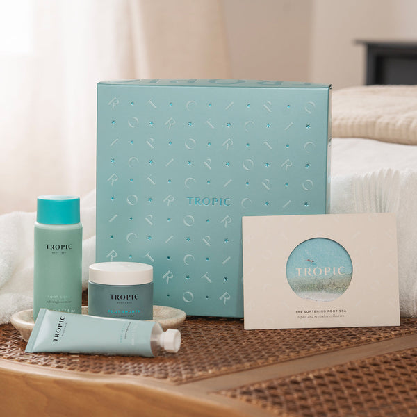 The Softening Foot Spa - repair and revitalise collection by Tropic. A light blue gift set box displayed with matching products: Foot Soak hydrating treatment, Foot Smooth intensive balm, a Repairing foot Remedy and card.