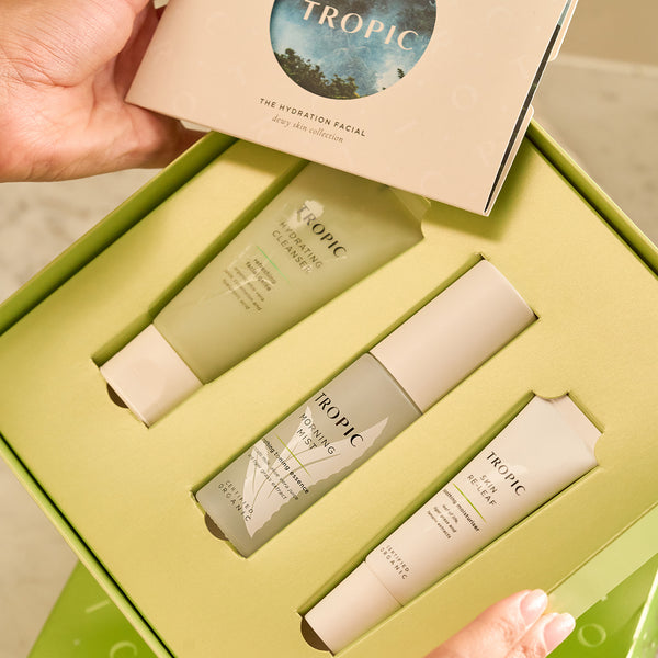 Close-up of The Hydration Facial – Dewy Skin Collection gift set by Tropic Skincare, featuring Hydrating Cleanser, Morning Mist, and Skin Re-Leaf products in a green box.