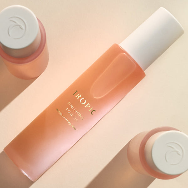 A Tropic Finishing Touch setting spray bottle with soft peach tones.