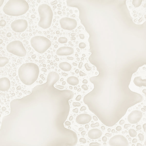 A soft white foamy texture with airy bubbles and a lightweight.