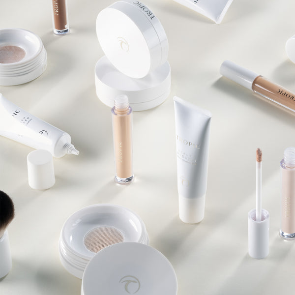 This image shows Beauty Booster, Illuma concealer, mineral foundation and the full coverage kabuki brush all laid out neatly on a white surface.