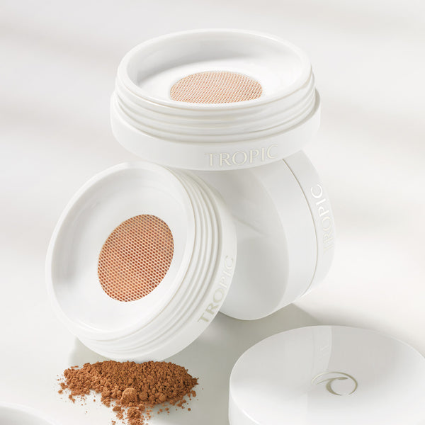 This image shows three mineral foundations stacked on top of each other in various shades. You can see the inside of the product with the mesh visible. There is some mineral foundation on the surface to show the shade and what it looks like.