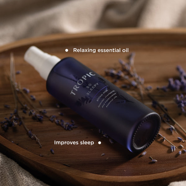 So sleepy pillow mist laid on a wooden board with lavender. This product improves sleep and has relaxing essential oil.