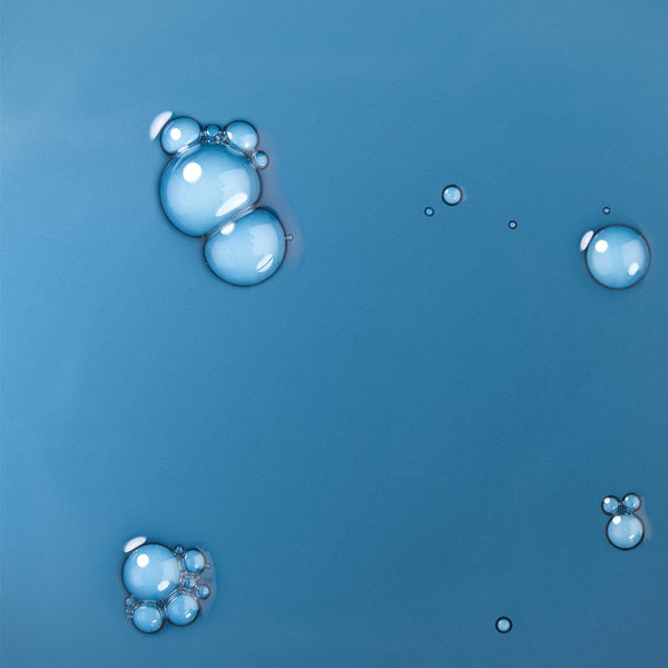 Blue liquid texture with glossy bubbles, representing Ocean Dive Pore-Clearing Serum.