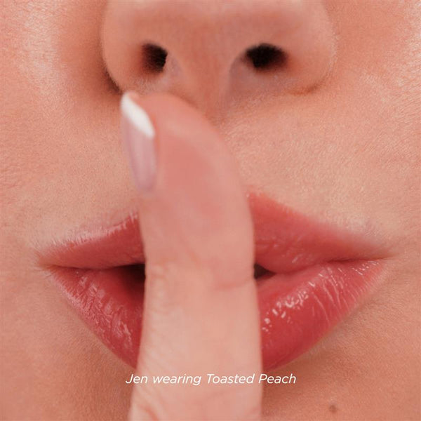 Model wears Limited Edition Lip Stain in shade Toasted Peach.