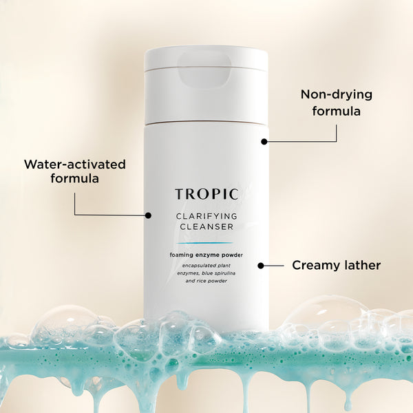 This image features Clarifying Cleanser, a foaming enzyme powder. Key features are annotated:

Water-activated formula, transforming into a creamy lather upon contact with water.
Non-drying formula to gently cleanse without stripping the skin.
Contains encapsulated plant enzymes, blue spirulina, and rice powder for a clarifying and nourishing cleanse.
The product is displayed with a fresh, foamy backdrop, emphasising its effective yet gentle cleansing action.