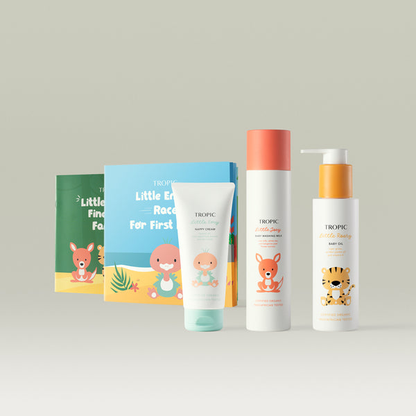 Little Tropic bundle contains: Little Emy Nappy Cream 100ml, Little Joey Baby Washing Milk 200ml, Little Roary Baby Oil 100ml and 2x Storybooks on a light gray background.