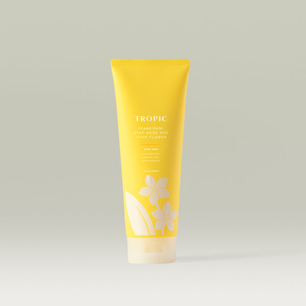 Tropic Frangipani, Star Anise and Tiare Flower Body Wash in a bright yellow tube with floral design.