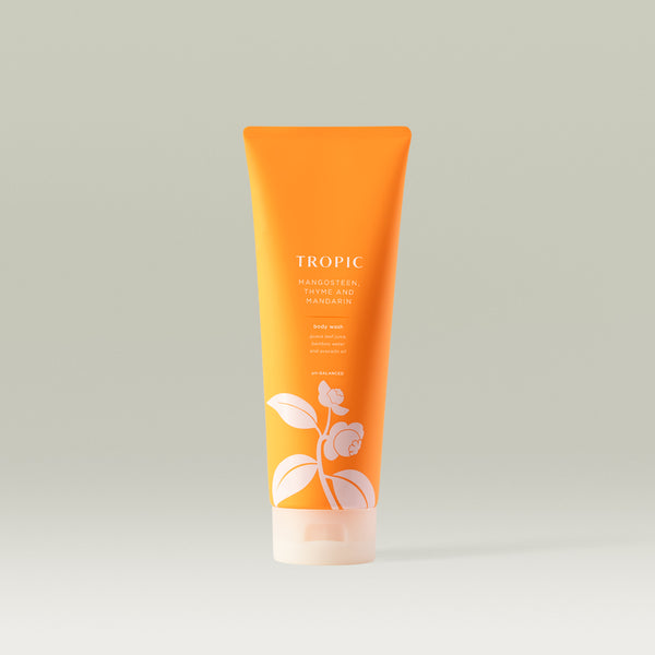 Tropic Mangosteen, Thyme and Mandarin Body Wash in a vibrant orange tube with botanical design.