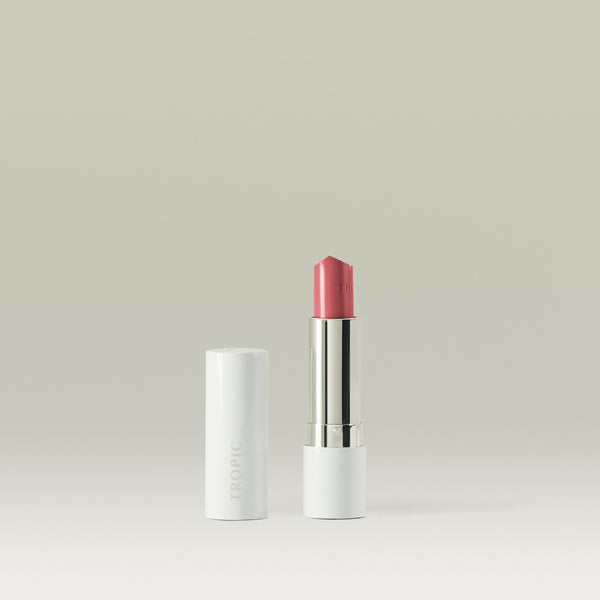 Tropic Butter Tint with pink shade displayed beside its white cap on a clean neutral background.