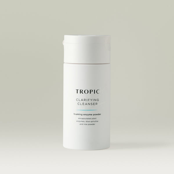 Tropic Clarifying Cleanser foaming enzyme powder encapsulated plant enzymes, blue spirulina and rice powder. This is a white bottle with a white flip cap.