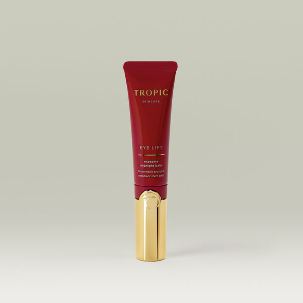 Tropic Skincare Eye Lift Exosome Midnight Balm in a sleek red and gold tube.