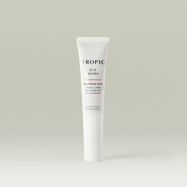 Tropic Eye Work rejuvenating serum. Vitamin C, Coffee Cherry Extract and Hibiscus Peptides. 
White tube with faint leaf design behind black text. White Lid.