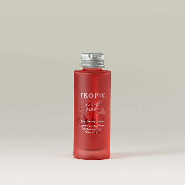 Tropic Glow Berry brightening serum Refill. Vitamin C, superberries and kangaroo paw flower extract. Deep red glass bottle with embossed floral design behind white text.