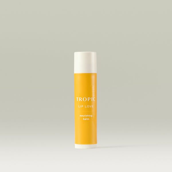 Tropic Lip Love nourishing balm in a yellow tube, designed to hydrate and protect lips.