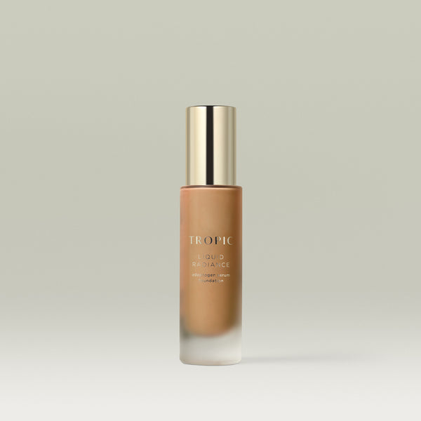 A pump bottle of Tropic Liquid Radiance adaptogen serum foundation in shade 8