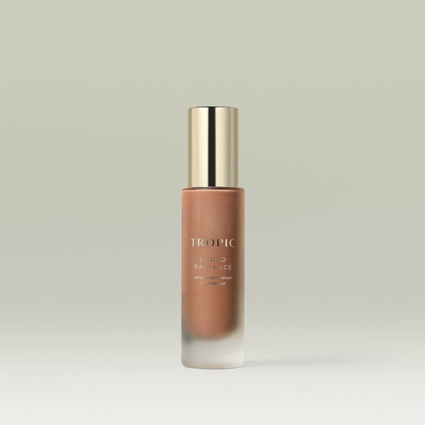 A pump bottle of Tropic Liquid Radiance adaptogen serum foundation in shade 9
