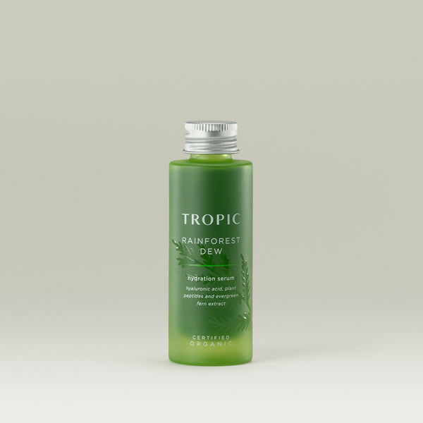 Tropic Rainforest Dew hydration serum Refill. Contains hyaluronic acid, plant peptides and evergreen fern extract. Certified Organic. 
Aluminium screw cap on a green glass bottle. Embossed leaf design behind white text.