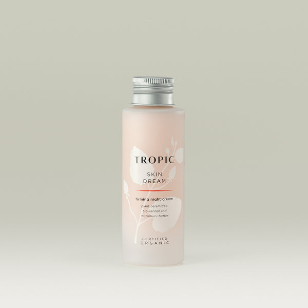 A bottle of Tropic Skin Dream firming night cream with plant ceramides, bio-retinol, and murumuru butter, certified organic, against a light neutral background.
