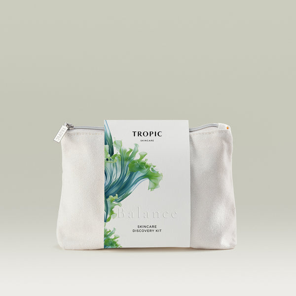 Tropic Skincare Discovery Kit – Balance edition, shown in a white zip travel bag with a label featuring a green and blue botanical design.