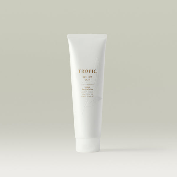 Tropic Summer Skin gradual tanning lotion. White tube with white leaf design and text in gold.