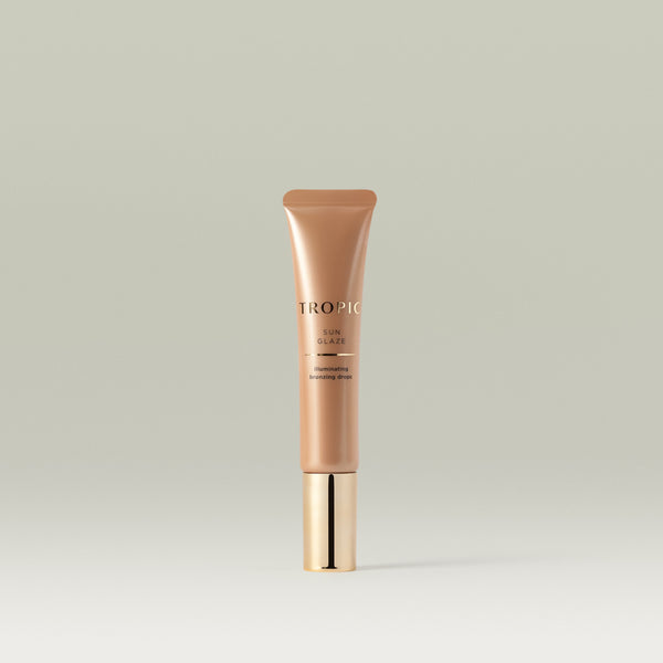 Tropic Sun Glaze illuminating bronzing drops. Bronze tube with gold lid.