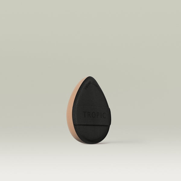 Velvet cushion makeup sponge with soft side and black underside with strap for your fingers to go though to hold the sponge on your hand.