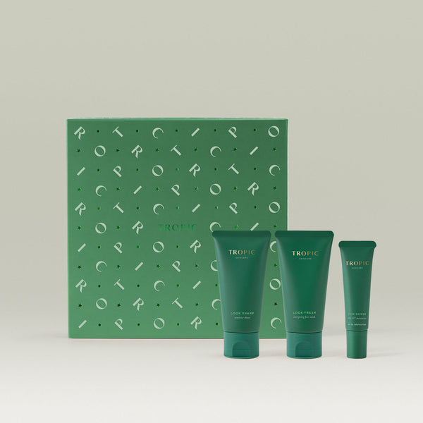 Tropic Skincare gift set titled The Wakeup Call – energising skincare essentials, featuring three products (Look Sharp, Look Fresh face wash, and Sun Shield daily SPF) displayed in front of a stylish green patterned box.